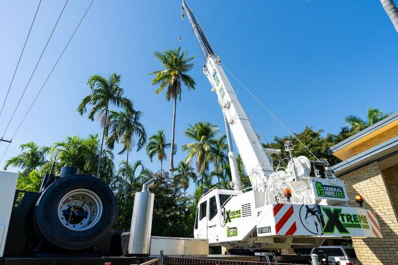 Xtreme Garden Care crane truck set up on a residential street